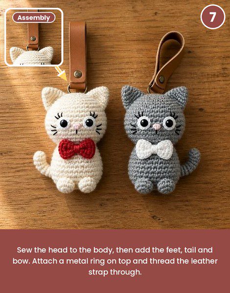 Finished crochet cat keychain pattern with a leather strap through a metal ring.