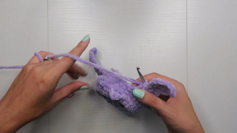 The eyes attached to the front of the head with a yarn needle.
